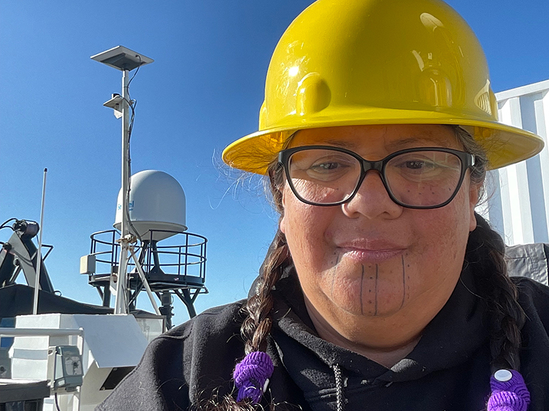 Mia Lopez observing autonomous underwater vehicle operations on deck aboard NOAA Ship Okeanos Explorer during the 2023 EXPRESS: Exploration of Central California Coast expedition.