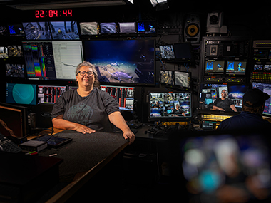 Mia Lopez from the Coastal Band of the Chumash Nation in the control room of NOAA Ship <i>Okeanos Explorer</i> during a live land acknowledgement.