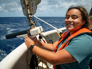 Jennifer Clifton, a member of the Beyond the Blue: Hawai‘i Mapping expedition mapping team, gets ready to launch an expendable bathythermograph, or “XBT” for short, cast from NOAA Ship Okeanos Explorer.