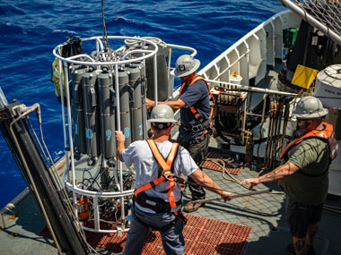 CTD stands for conductivity, temperature, and depth, and refers to a package of electronic instruments that measure these properties. The CTD is an essential tool used in all disciplines of oceanography, providing important information about physical, chemical, and even biological properties of the water column. In this image, taken during the Beyond the Blue: Hawai‘i Mapping expedition on NOAA Ship Okeanos Explorer, the team prepares to conduct CTD operations.