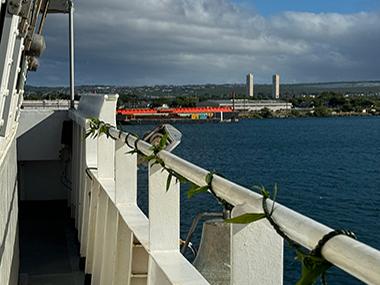 Image of the lei wrapped by our cultural liaisons, Malia and Makoa, around the railing of the bridge for the Beyond the Blue: Papahānaumokuākea Mapping 1 expedition. The bridge is the nerve center of the ship where all of the navigating and main ship operations happen.