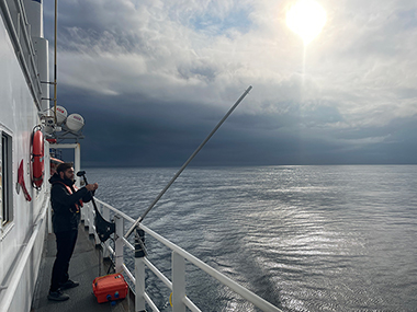 Explorer-in-training Joe Guzek assists with setting up to calibrate the EK split-beam sonar on NOAA Ship <i>Okeanos Explorer</i> during the Seascape Alaska 4 expedition.