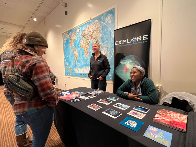 NOAA Ocean Exploration staff members Susan Haynes and Shellby Rodney-Johnson table at the first annual Seward Marine Science Symposium in Seward, Alaska, after the completion of the Seascape Alaska 5 expedition.