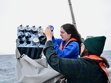 Explorer-in-training Adrianna Ebrahim works with NOAA Ocean Exploration expedition coordinator team lead Shannon Hoy to launch the expendable bathythermographs, or XBTs, during the Seascape Alaska 6 expedition. XBTs are small torpedo-shaped probes used to measure temperature throughout the water column, generating a temperature profile. Scientists then use software that combines temperature profiles from an XBT with surface salinity data to determine an overall sound speed profile. The sound speed values can then be applied to multibeam soundings in real time for an accurate measure of bathymetry.