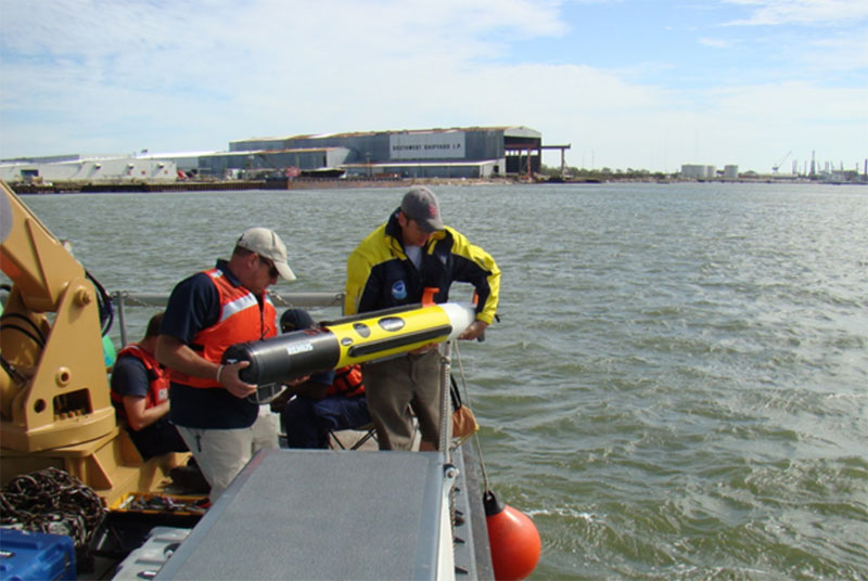 Coast Survey’s Hydroid REMUS-100 AUV being deployed from a Coast Guard vessel in Galveston Harbor during a response survey following Hurricane Ike.