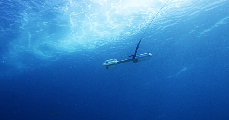 A geometrics cesium marine magnetometer is towed behind a research vessel.