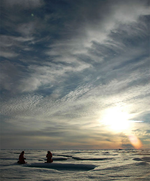 Scientists gather samples from a sea ice melt pond in the middle of the Arctic ‘night.’