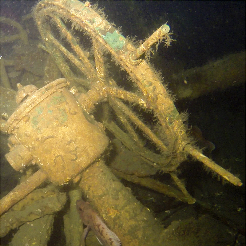 A view of the steering wheel on the bridge of U.S. Coast Guard Cutter McCulloch. McCulloch sank when it collided with the passenger steamship SS Governor on June 13, 1917.